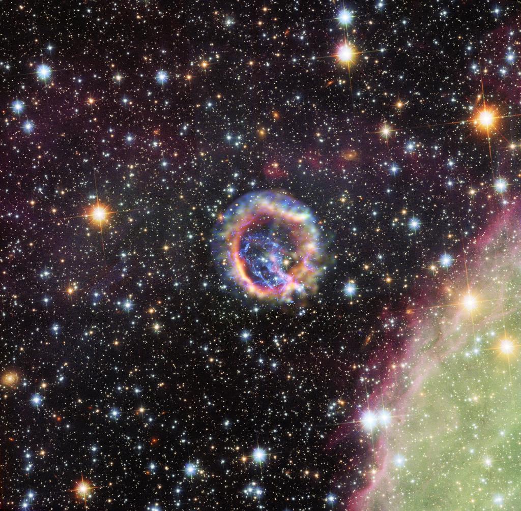 deep space image of round supernova remnant in galaxy